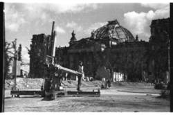 Der zerstörte Reichstag mit Soldat und sowjetische 122 mm Haubitze im Vordergrund